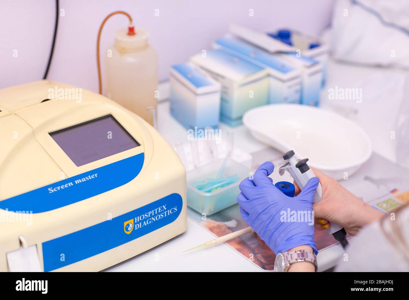 Blood analyzer. Laboratory assistant in medical laboratory holds test