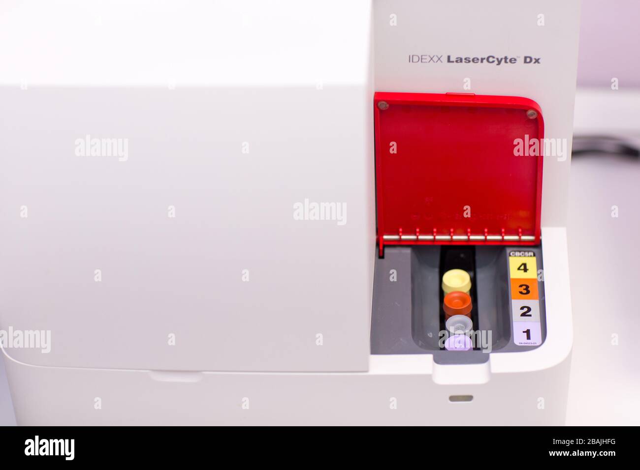 Laboratory analyzer in medical laboratory holds test tube with blood
