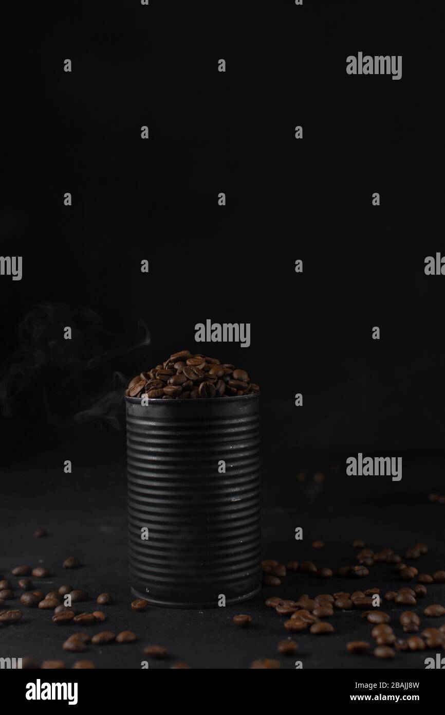 Roasted coffee beans in a black tin can, whole coffee beans in black can Stock Photo