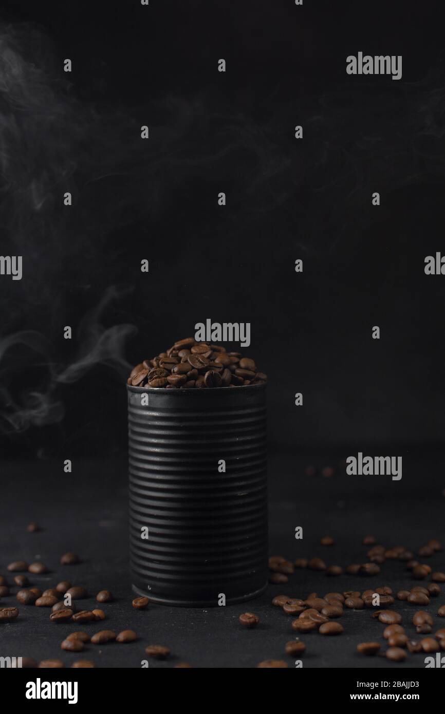 Roasted coffee beans in a black tin can, whole coffee beans in black can Stock Photo