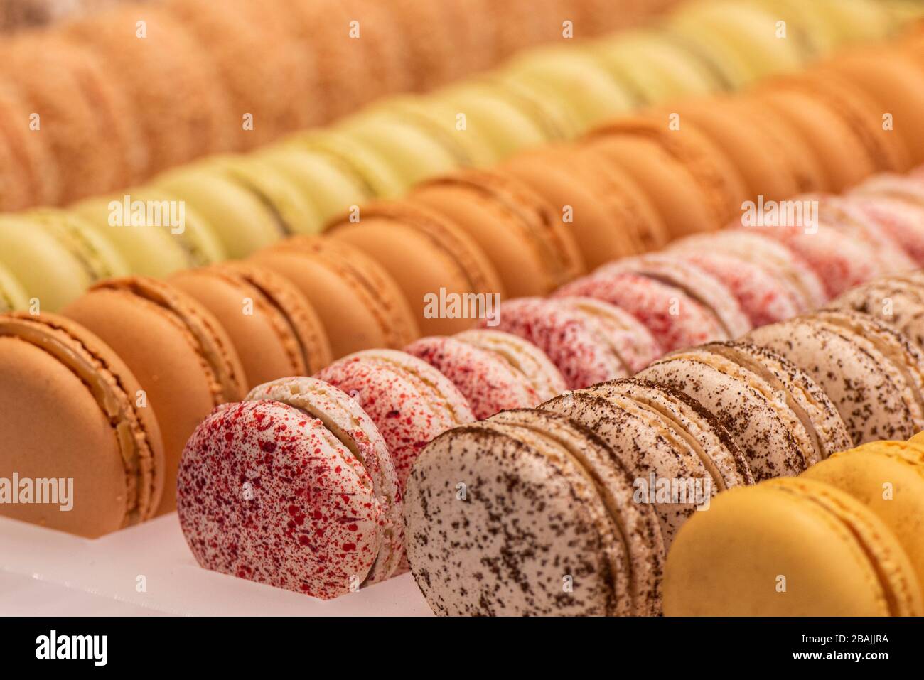 assorted macarones of various flavors in the showcase Stock Photo