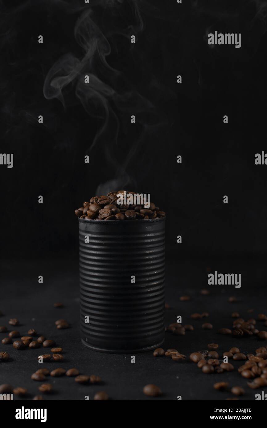Roasted coffee beans in a black tin can, whole coffee beans in black can Stock Photo