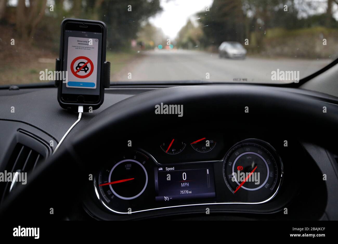 Waze the mobile phone sat-nav system displays a warning to only 'Drive only if necessary' as the UK continues in lockdown to help curb the spread of the coronavirus. Stock Photo