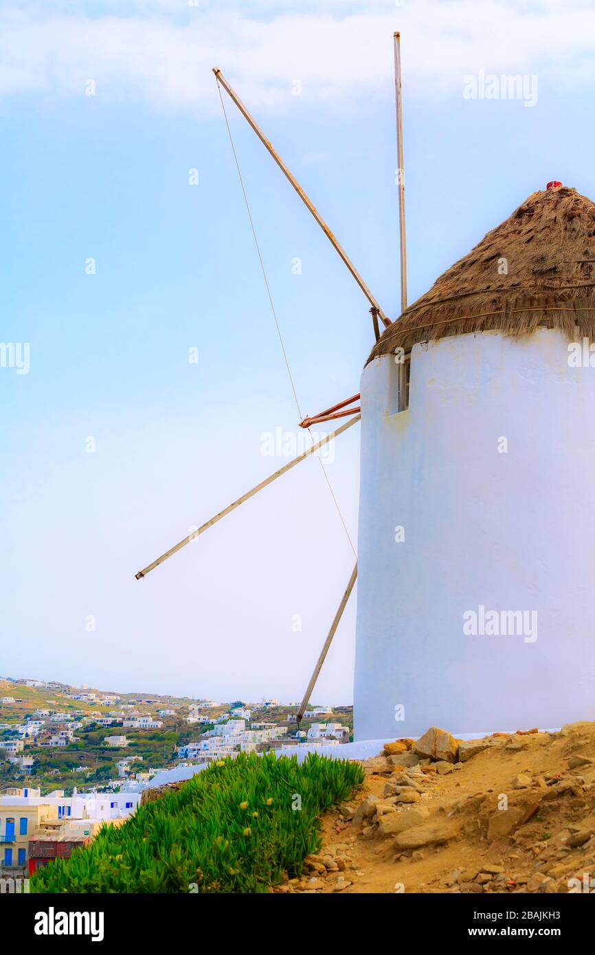 Greek iconic windmill and town panorama in Mykonos, Greece, famous Cyclades island Stock Photo