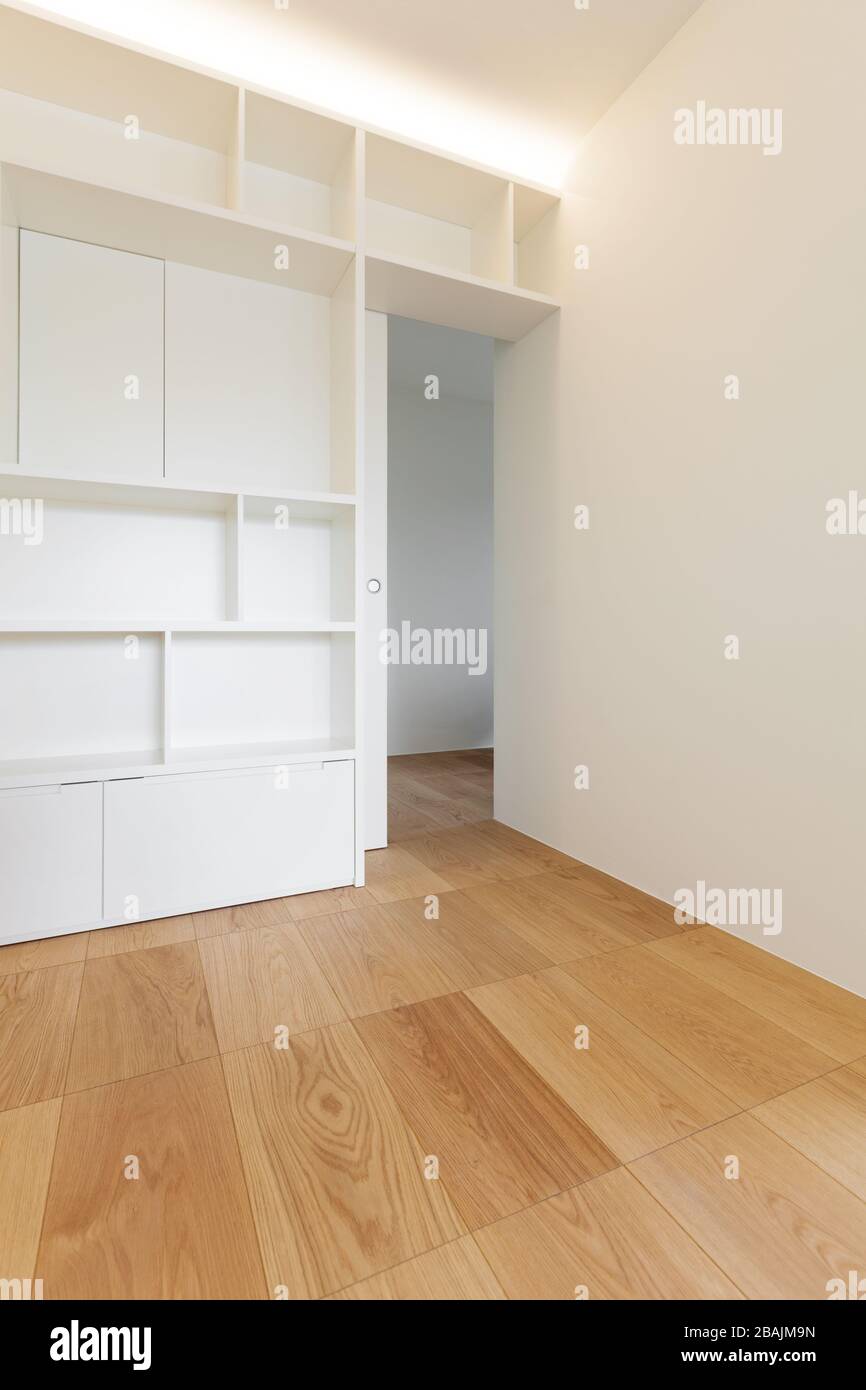Architecture, empty room of a new apartment, white bookcase Stock Photo