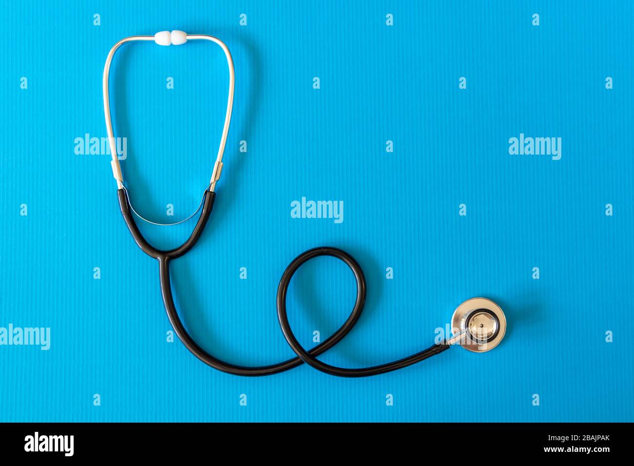 Black Stethoscope on blue background. Medical concept. Stock Photo