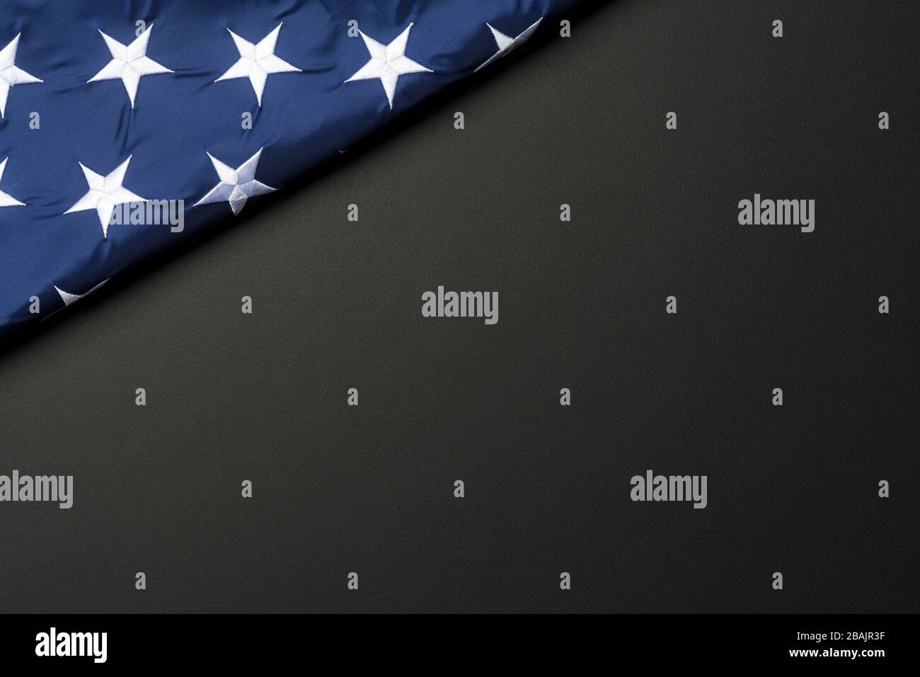 American flag lying on black grainy background Stock Photo