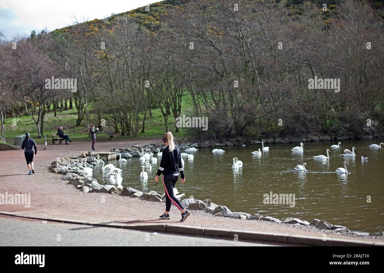 Edinburgh, Scotland, UK. 28th Mar 2020. Coronavirus effect, at 11am Saturday, deserted streets and fuel station, as a few people head for Holyrood Park to get their allowed exercise period but keeping a safe distance form each other. Stock Photo