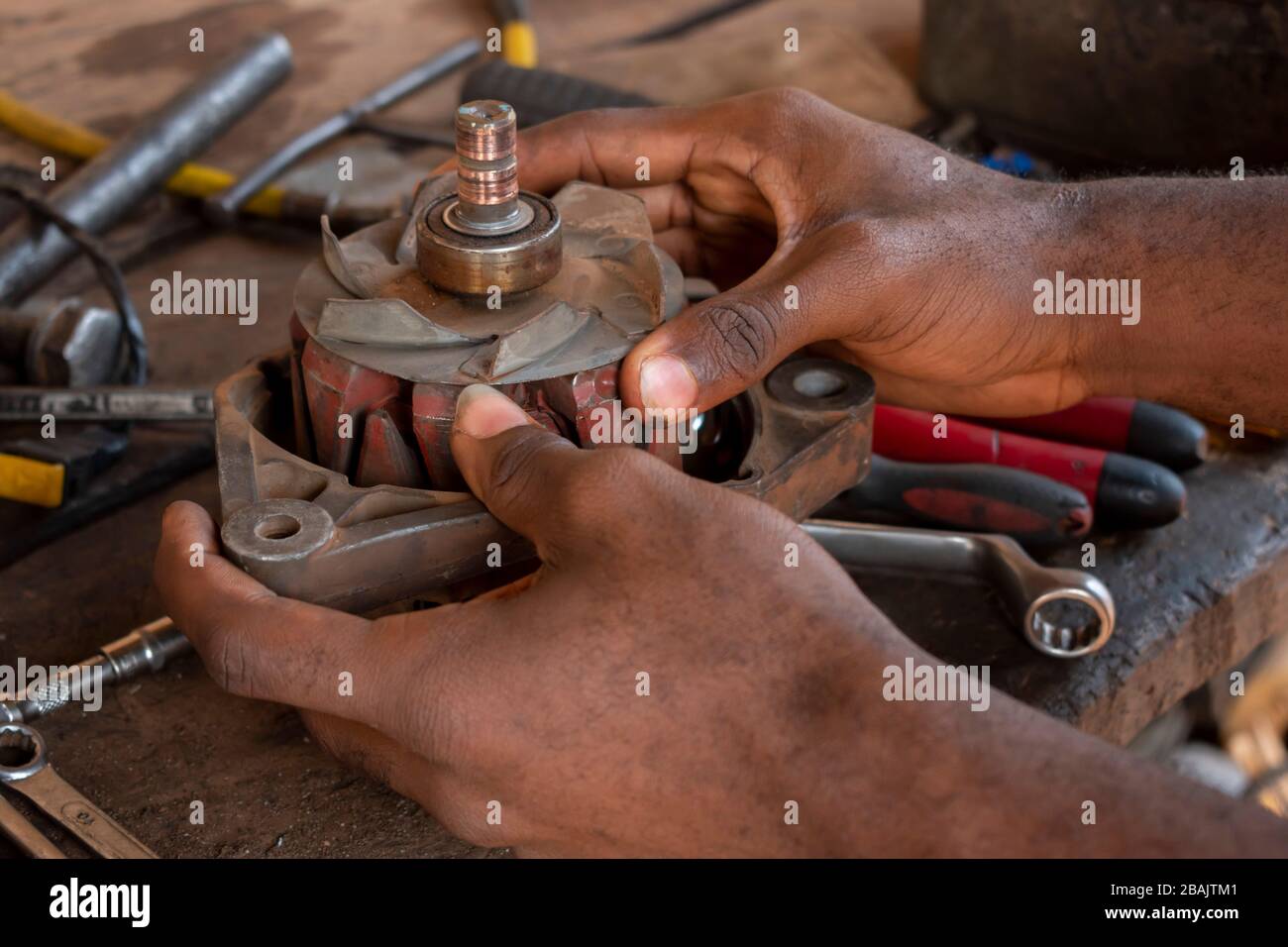hand working on a coil and tools on a mechanical table Stock Photo
