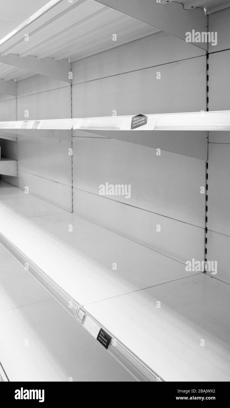 empty shelf in a shop with a sign saying temporarily out of stock Stock Photo