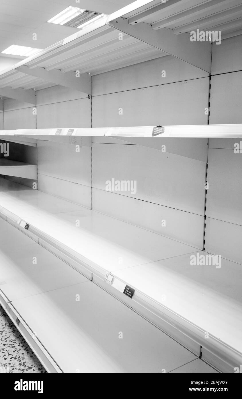 empty shelf in a shop with a sign saying temporarily out of stock Stock Photo