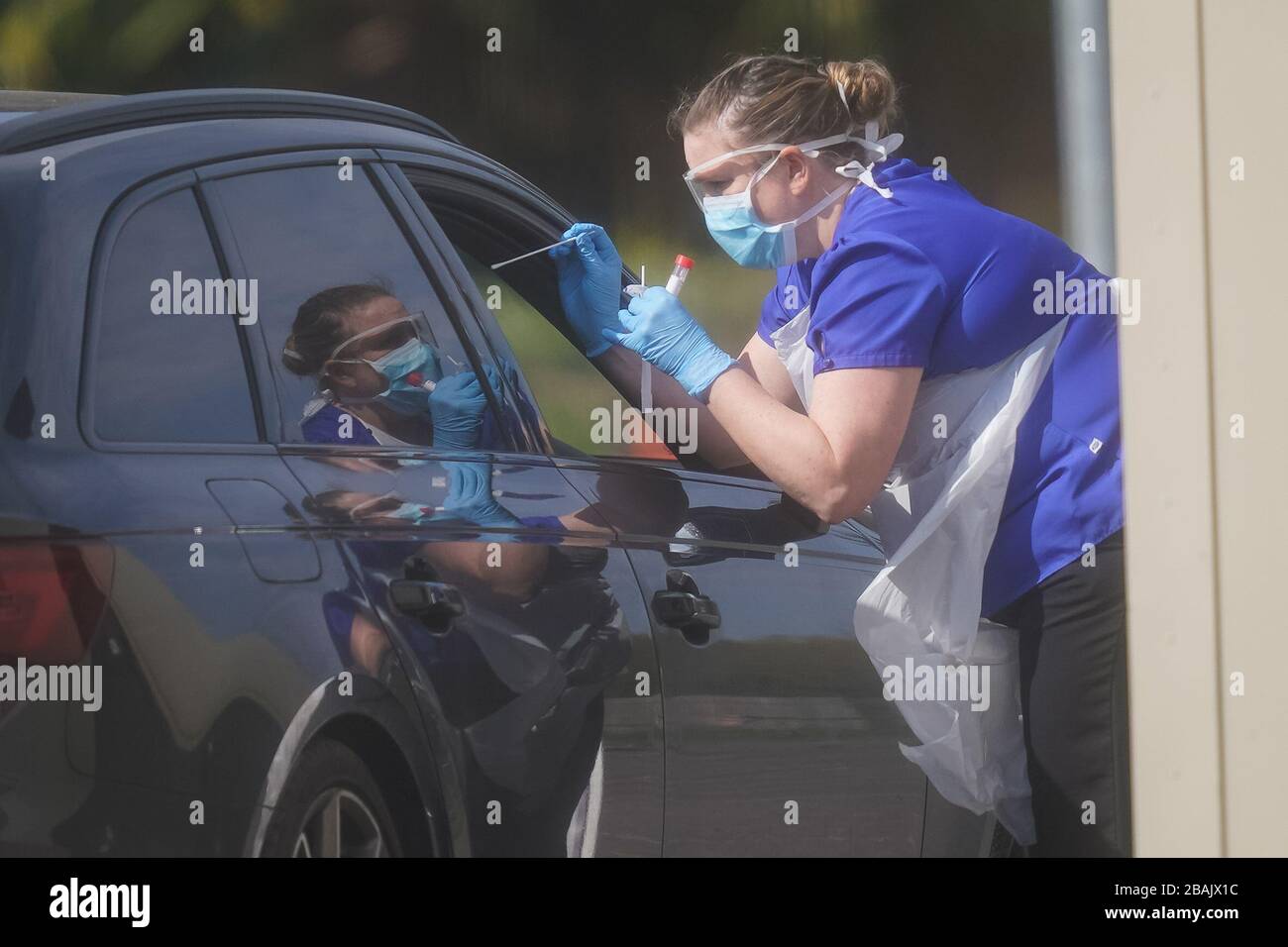 An NHS worker being tested for coronavirus at a temporary drive through testing station in the car park of Chessington World of Adventures in Chessington, Greater London. Stock Photo