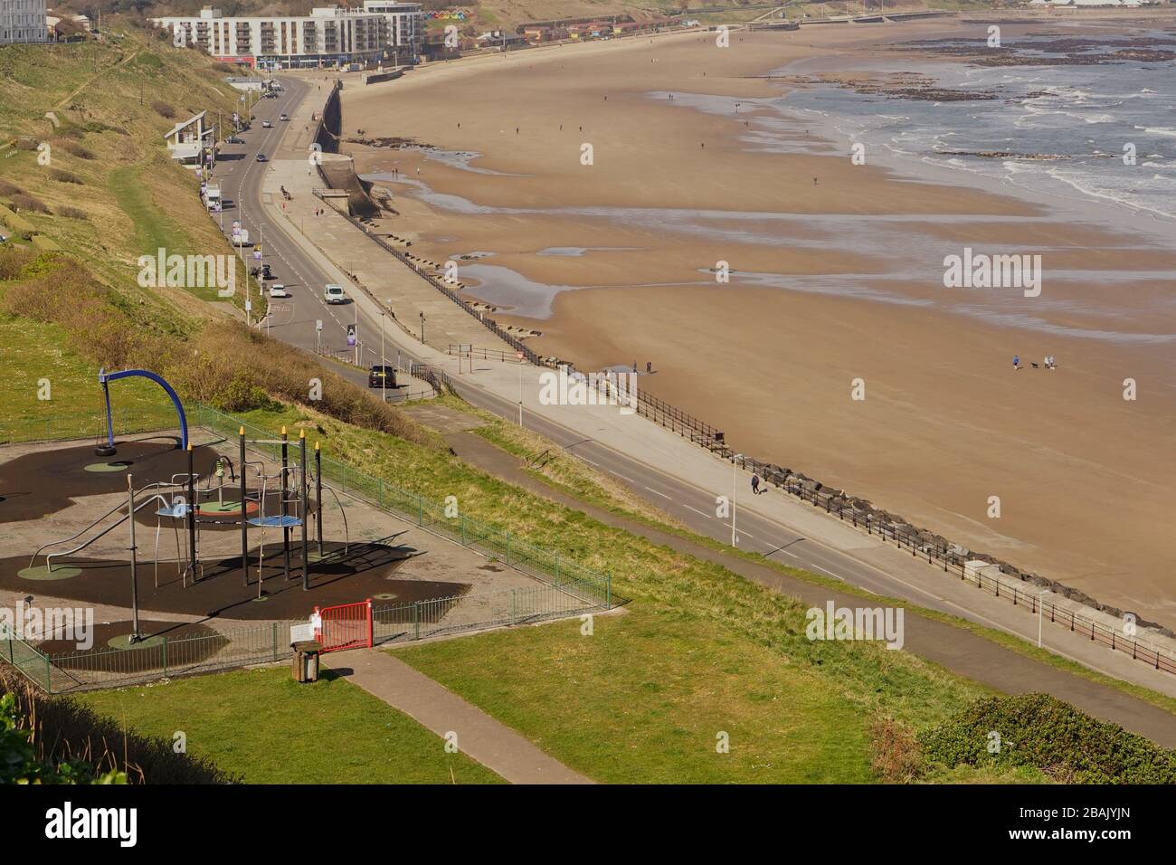 An empty playground and beach due to Coronavirus government lock down restrictions Stock Photo