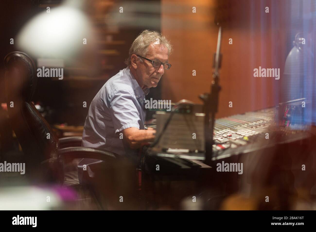 Mature man at mixing desk in a recording studio Stock Photo