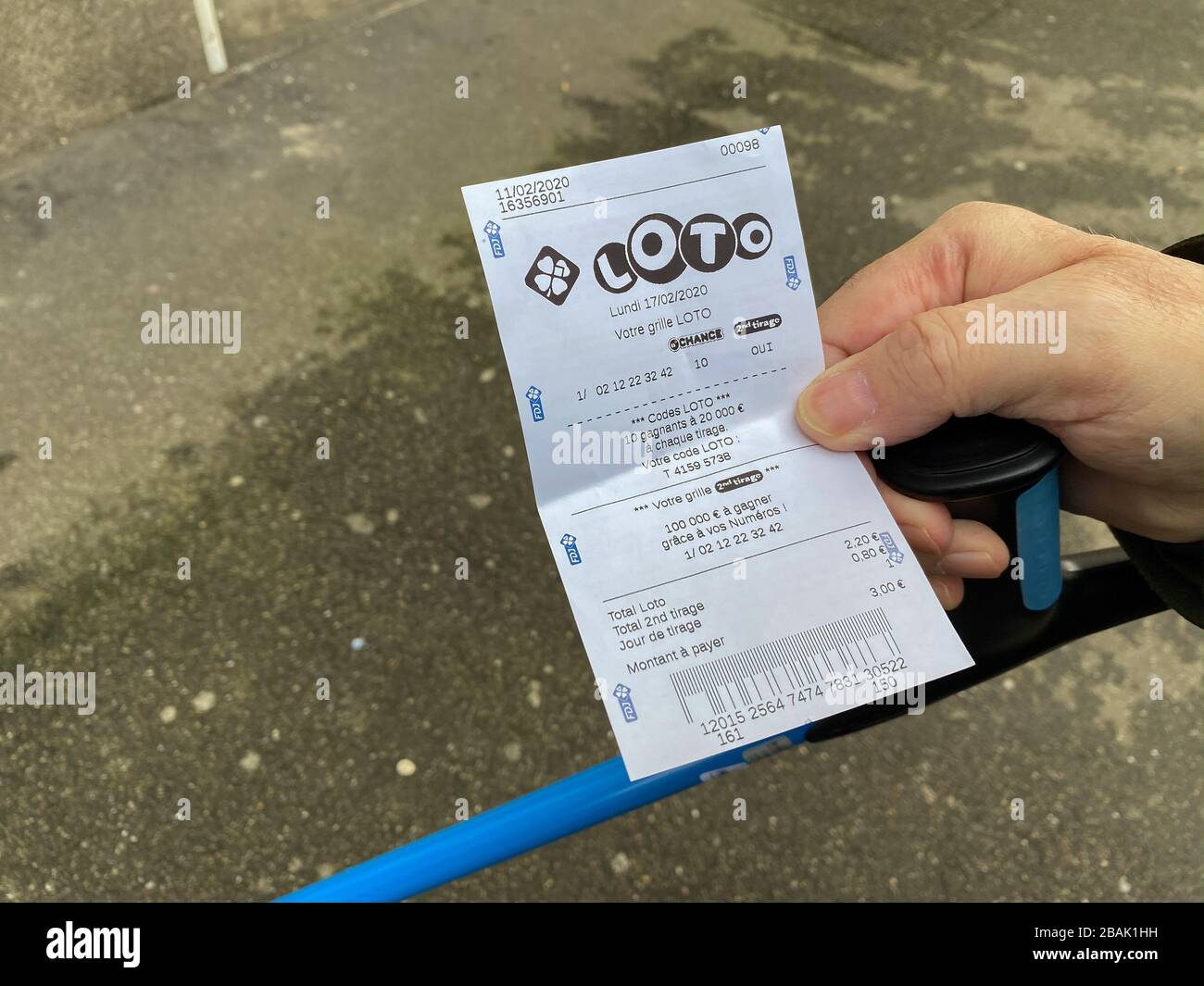 Paris, France - Feb 18, 2020: Senior male hand holding Lottery tickets for  Lotto with winning numbers Stock Photo - Alamy