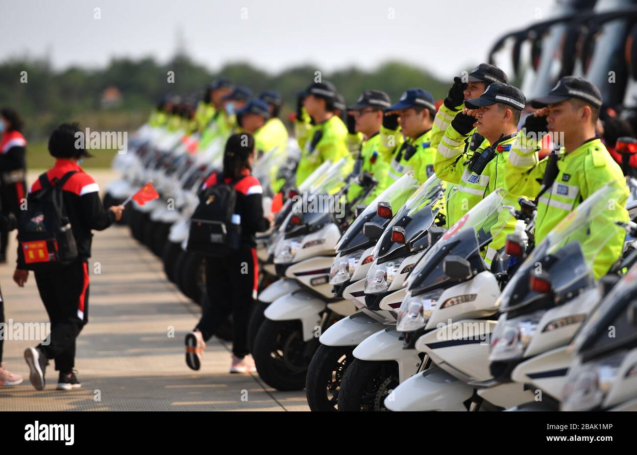 Haikou. 28th Mar, 2020. The police salute the medics at the airport in Haikou, capital of south China's Hainan Province on March 28, 2020. Hainan's last batch of medical assistance teams returned Saturday after completing their mission to aid the virus-hit Hubei. Credit: Guo Cheng/Xinhua/Alamy Live News Stock Photo