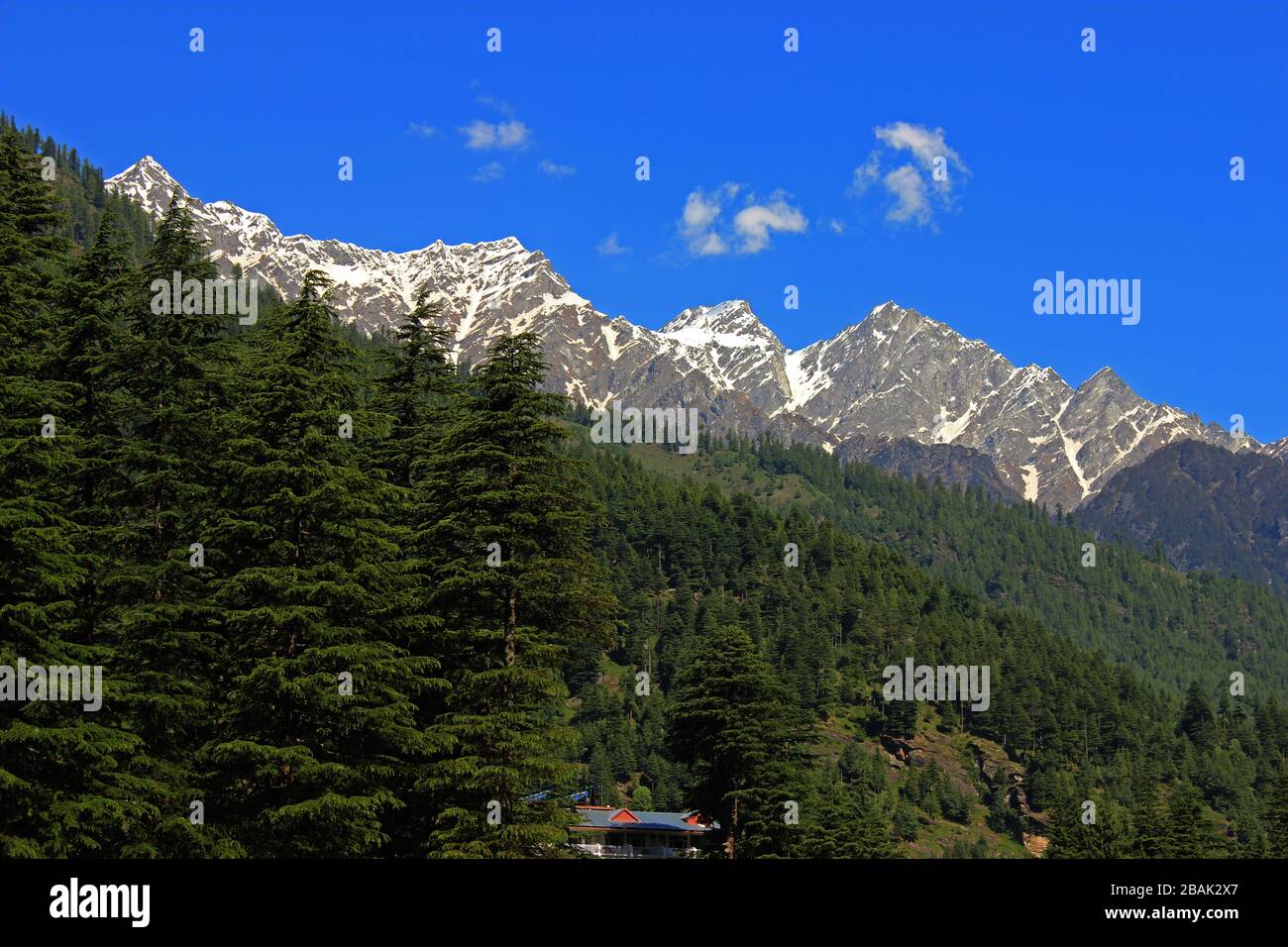 Snow clad himalayas viewed from The Beas River in Manali from Leh - manali highway in summer morning of May, India.Himachal Pradesh Stock Photo