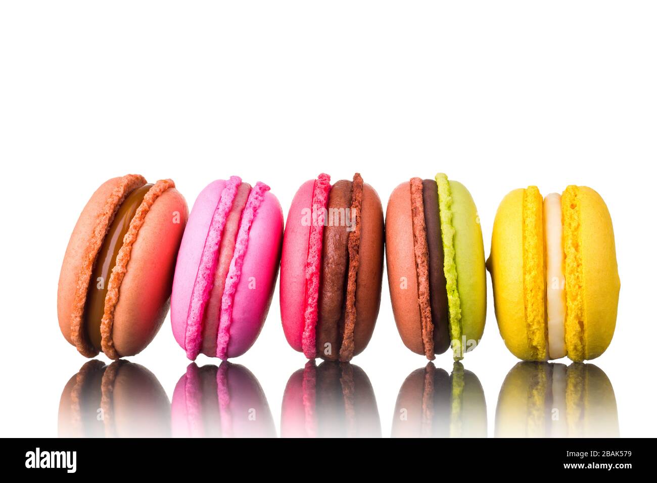 Stack of french colorful macaroons in row isolated on white background ...