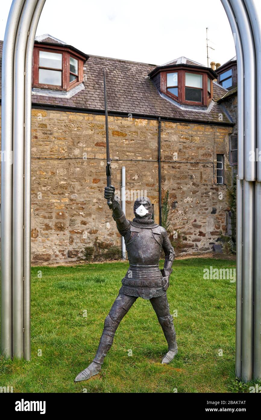 Alexandra Road, Elgin, Moray, UK. 28th Mar, 2020. UK. This is the statue for Alexander Stewart, Earl of Buchan, Alasdair Mór mac an Rígh, and called the Wolf of Badenoch (1343 - 20 June 1405), was the third surviving son of King Robert II of Scotland and youngest by his first wife, Elizabeth Mure of Rowallan. He has adorned his mask to fight COVID-19. Credit: JASPERIMAGE/Alamy Live News Stock Photo