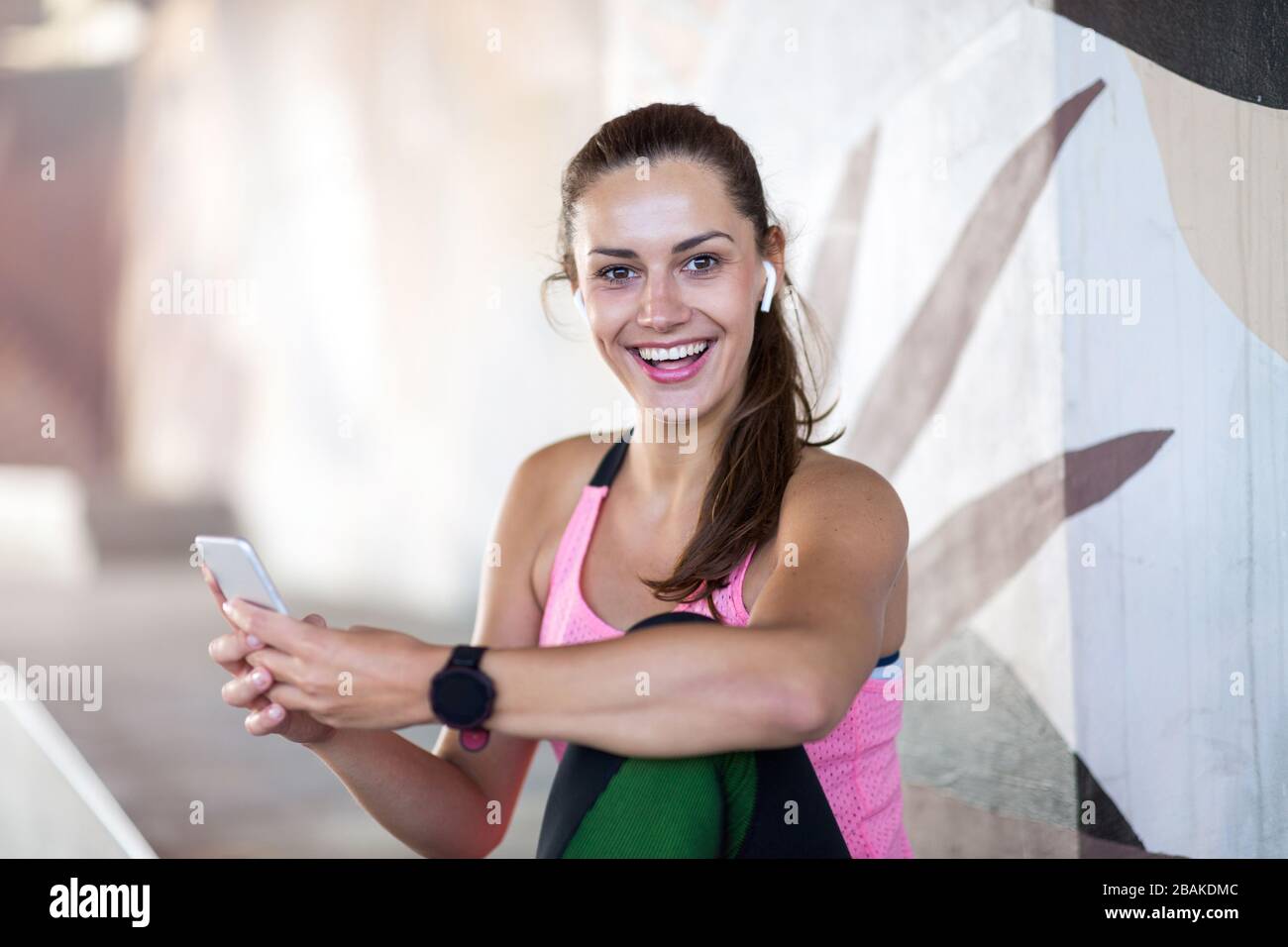Young woman doing fitness exercise in urban area Stock Photo