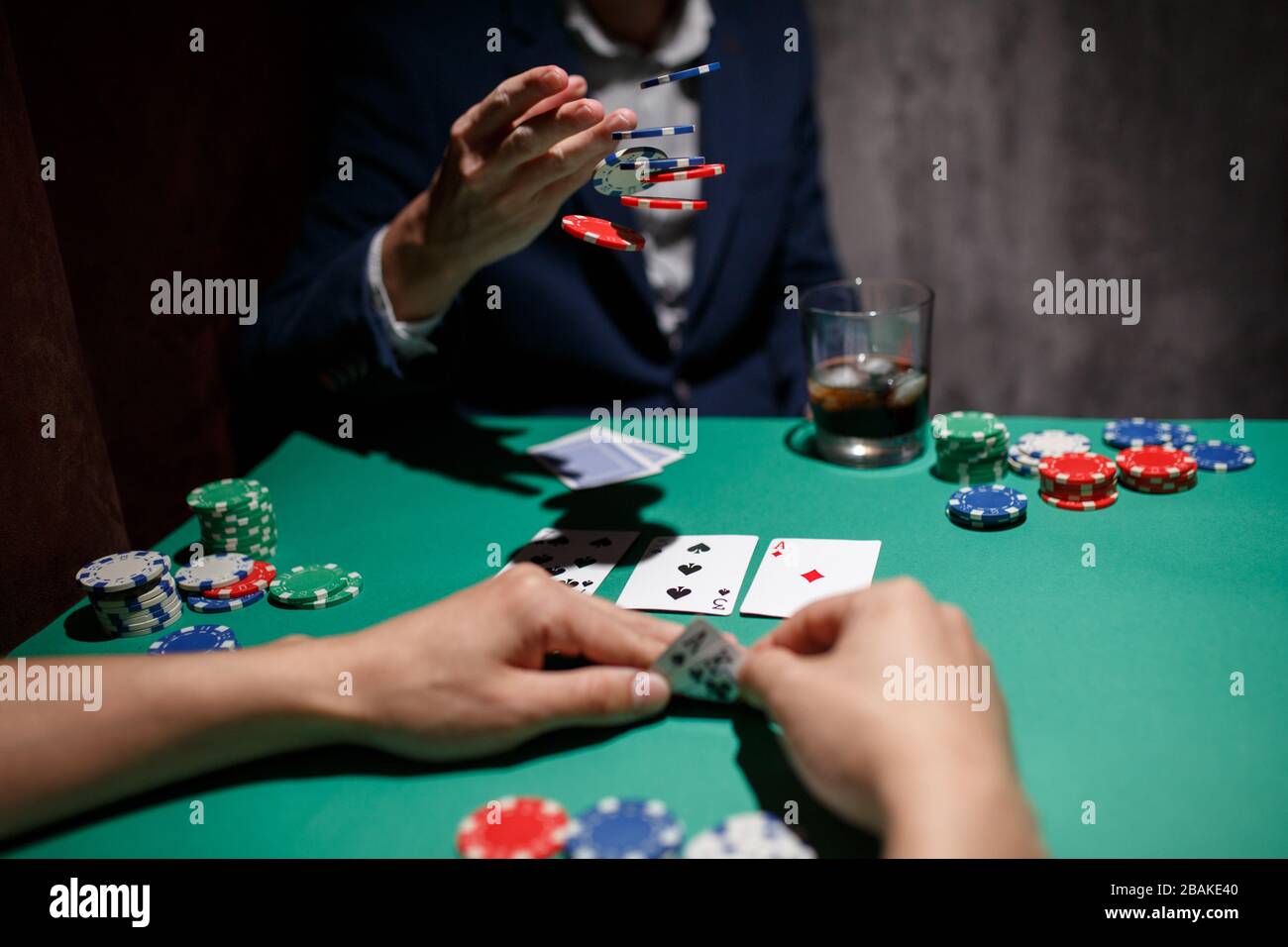 professional poker game. poker table with two games. poker player makes a  bet by throwing chips on the table Stock Photo - Alamy