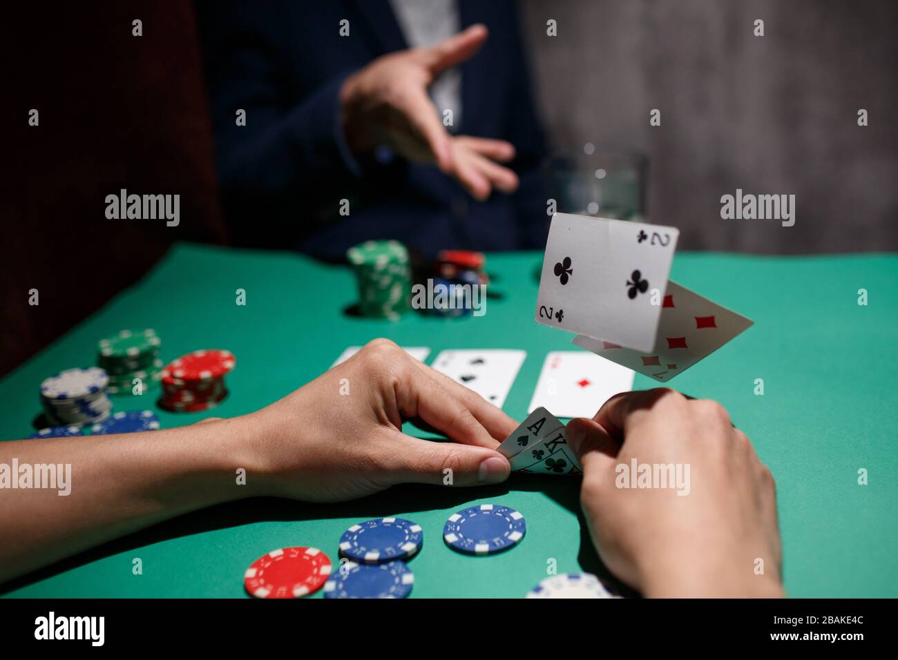 professional poker game. poker table with two games. poker player folds by  throwing cards on the table Stock Photo - Alamy