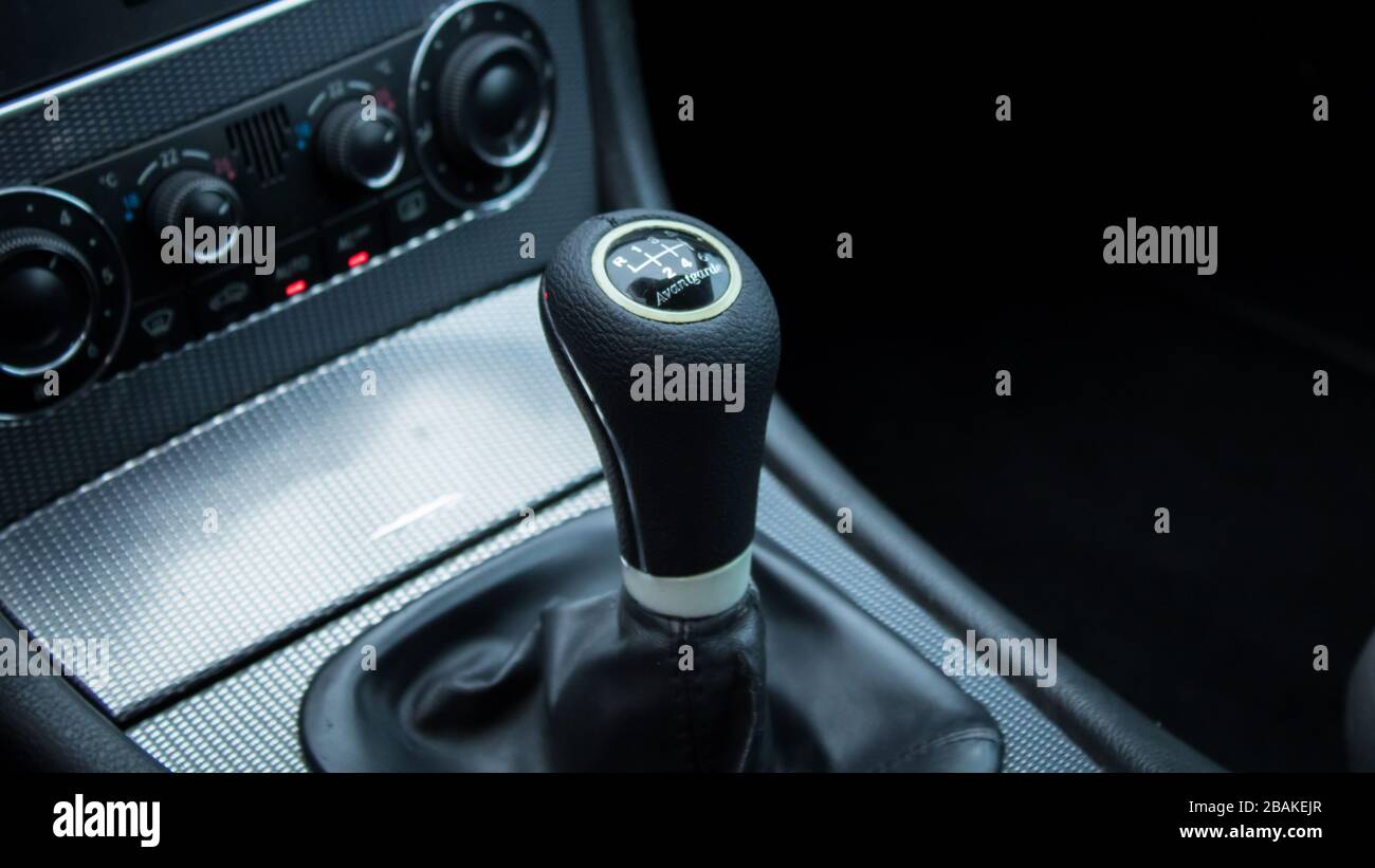 Inside car dashboard view.Detailed close-up photo of manual transmission knob/lever in neutral position.Leather upholstery,6 gear transmission/reverse Stock Photo