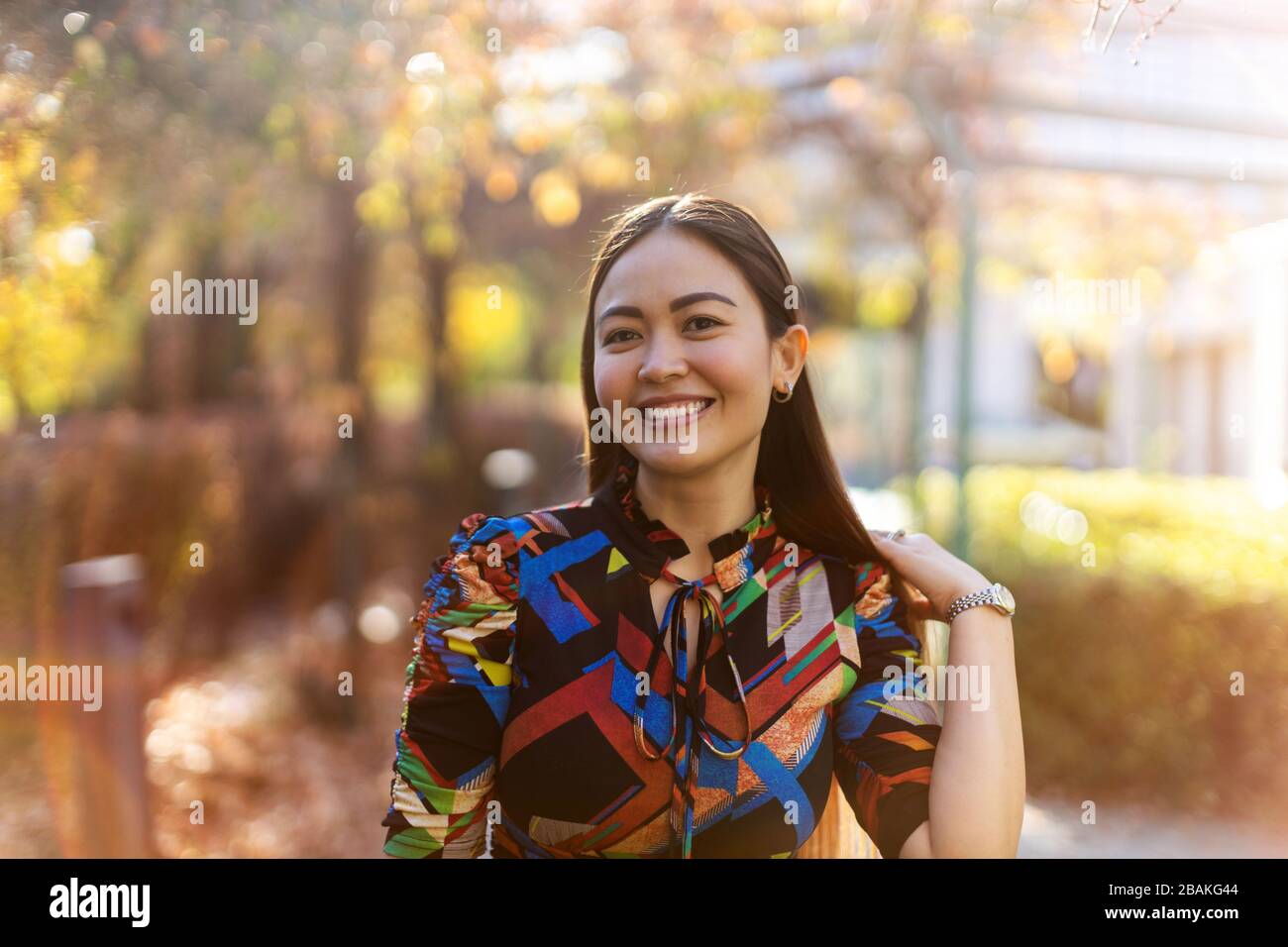 Attractive and happy young woman outdoors Stock Photo