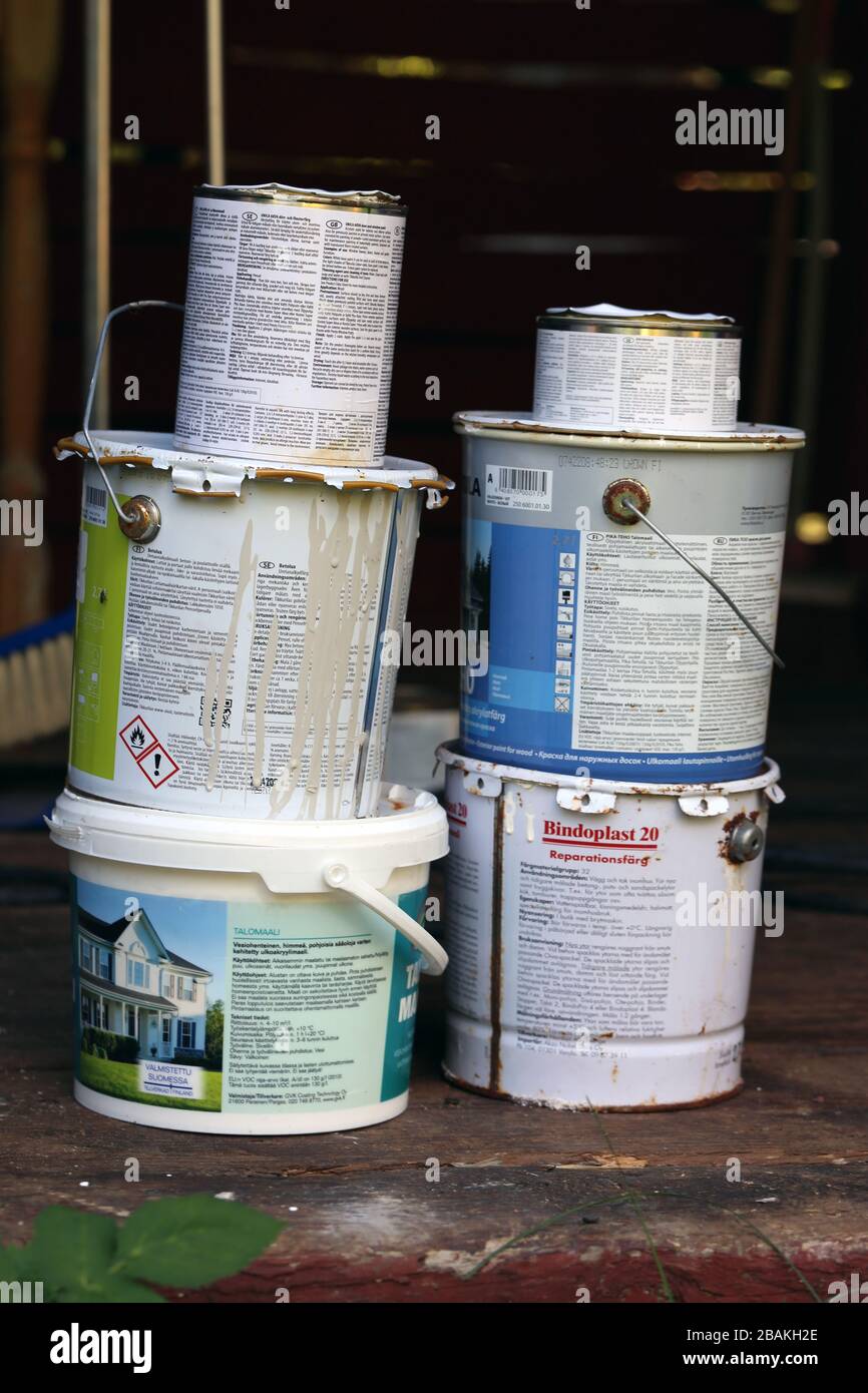 Multiple halfused paint buckets with different colored paint. The