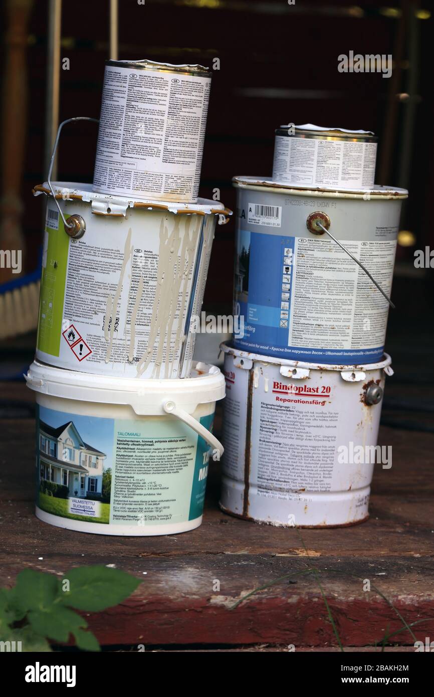 Multiple halfused paint buckets with different colored paint. The