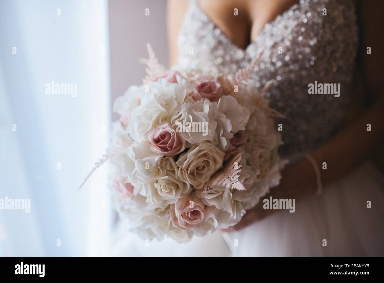 The bride in a beautiful wedding dress and her bridal bouquet of ...
