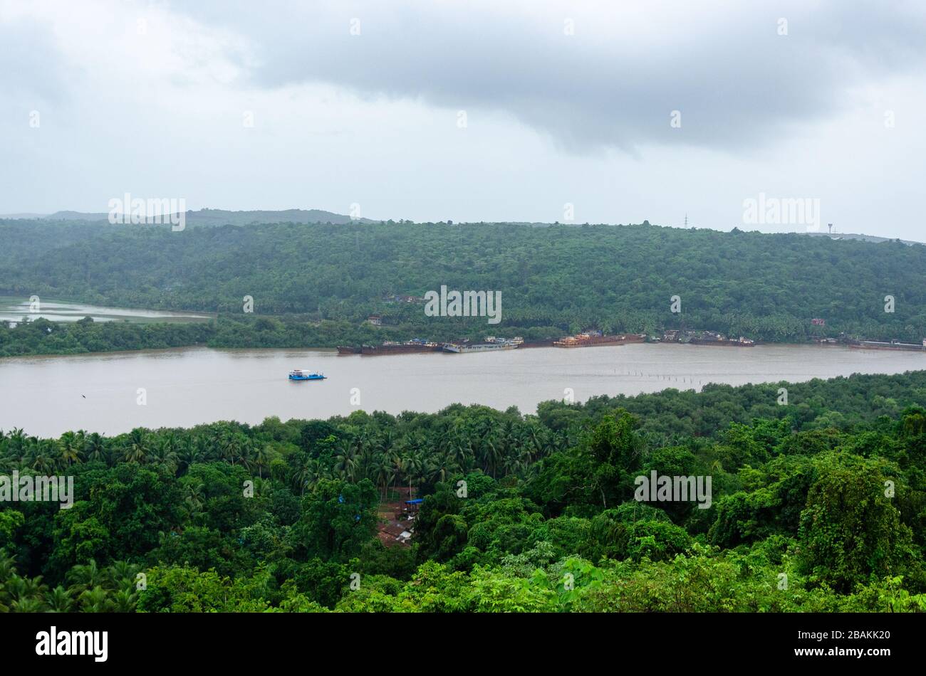 Beautiful view of Durbhat - Rassaim Ferryboat on the Zuari River under dark monsoon clouds as seen from Durbhat Hilltop, Ponda, Goa, India Stock Photo