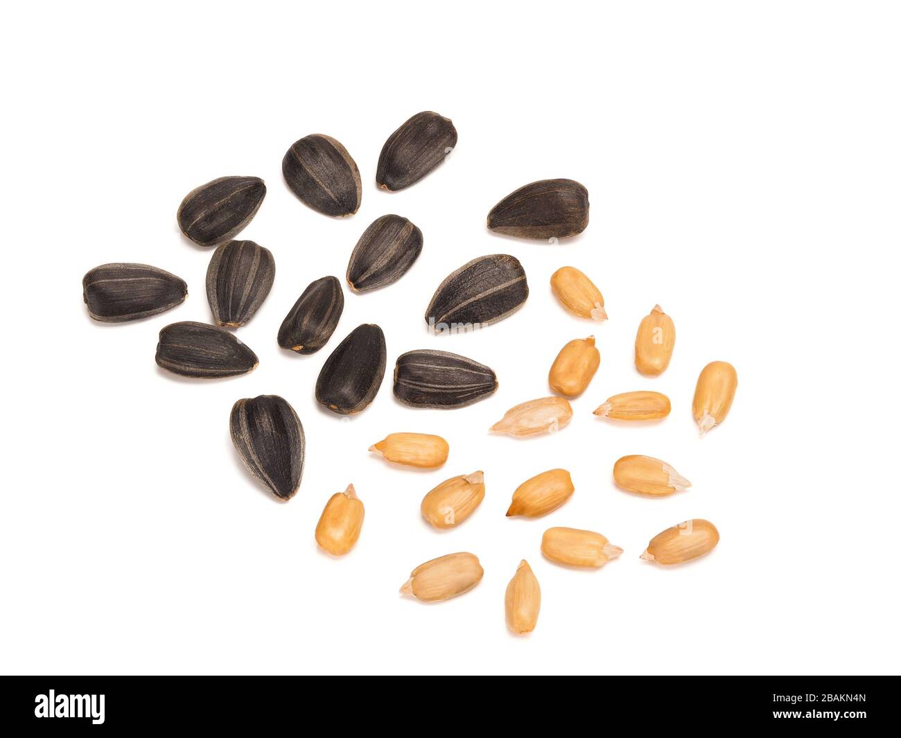 Black sunflower fried seeds peeled and unpeeled Stock Photo - Alamy