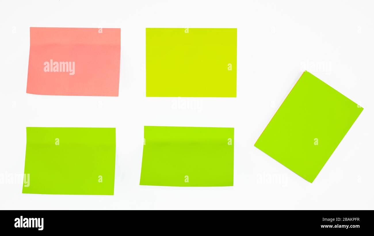 Five different colored paper sticky notes displayed before an isolated