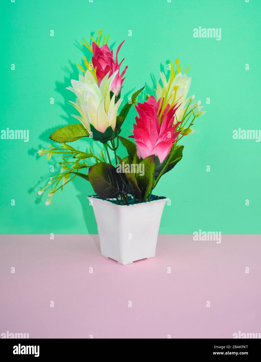 Portrait of a miniature flower bouquet with different colored small flowers on top of a desk Stock Photo