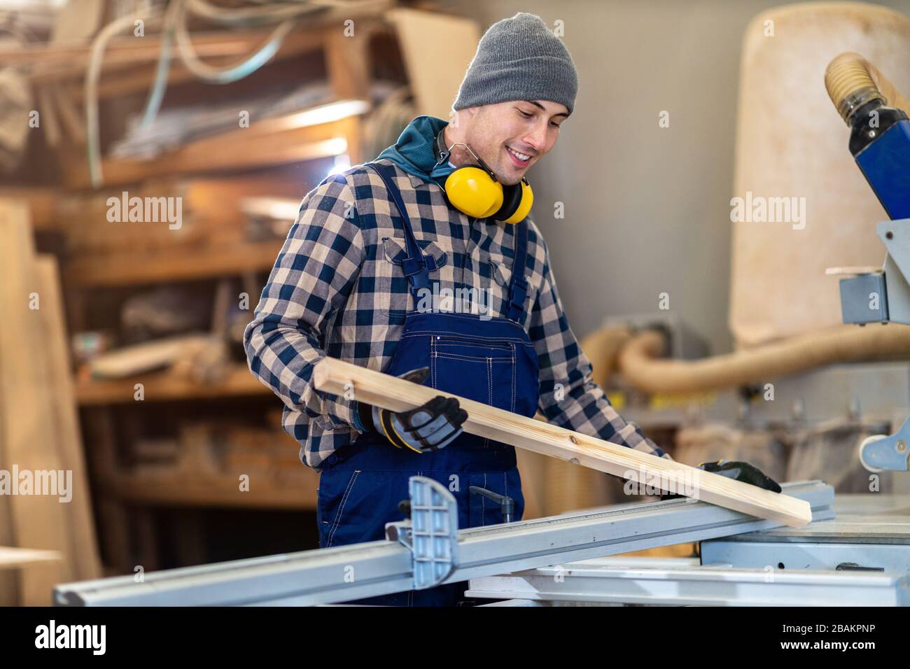 Young male worker in timber warehouse Stock Photo