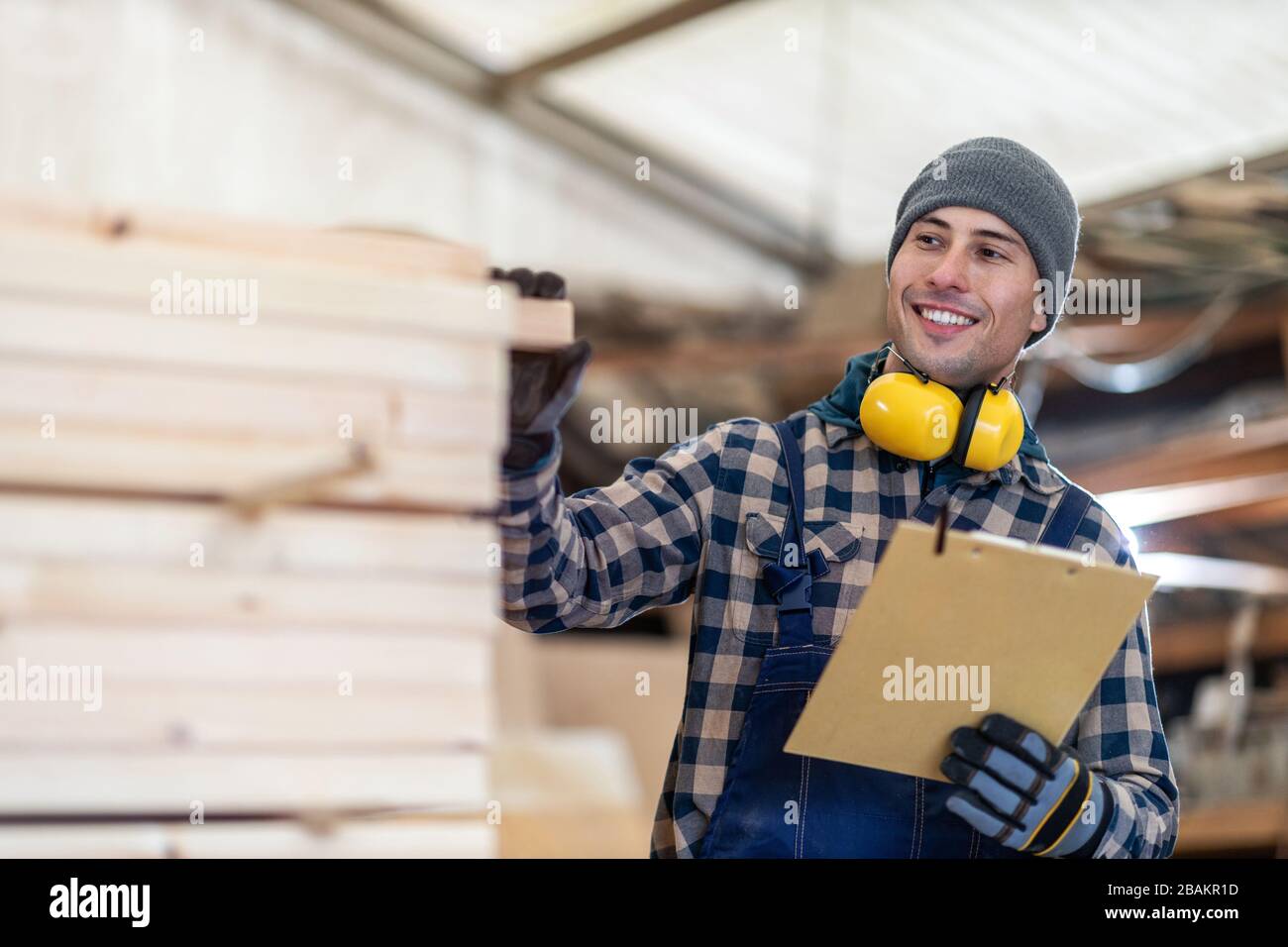 Young male worker in timber warehouse Stock Photo