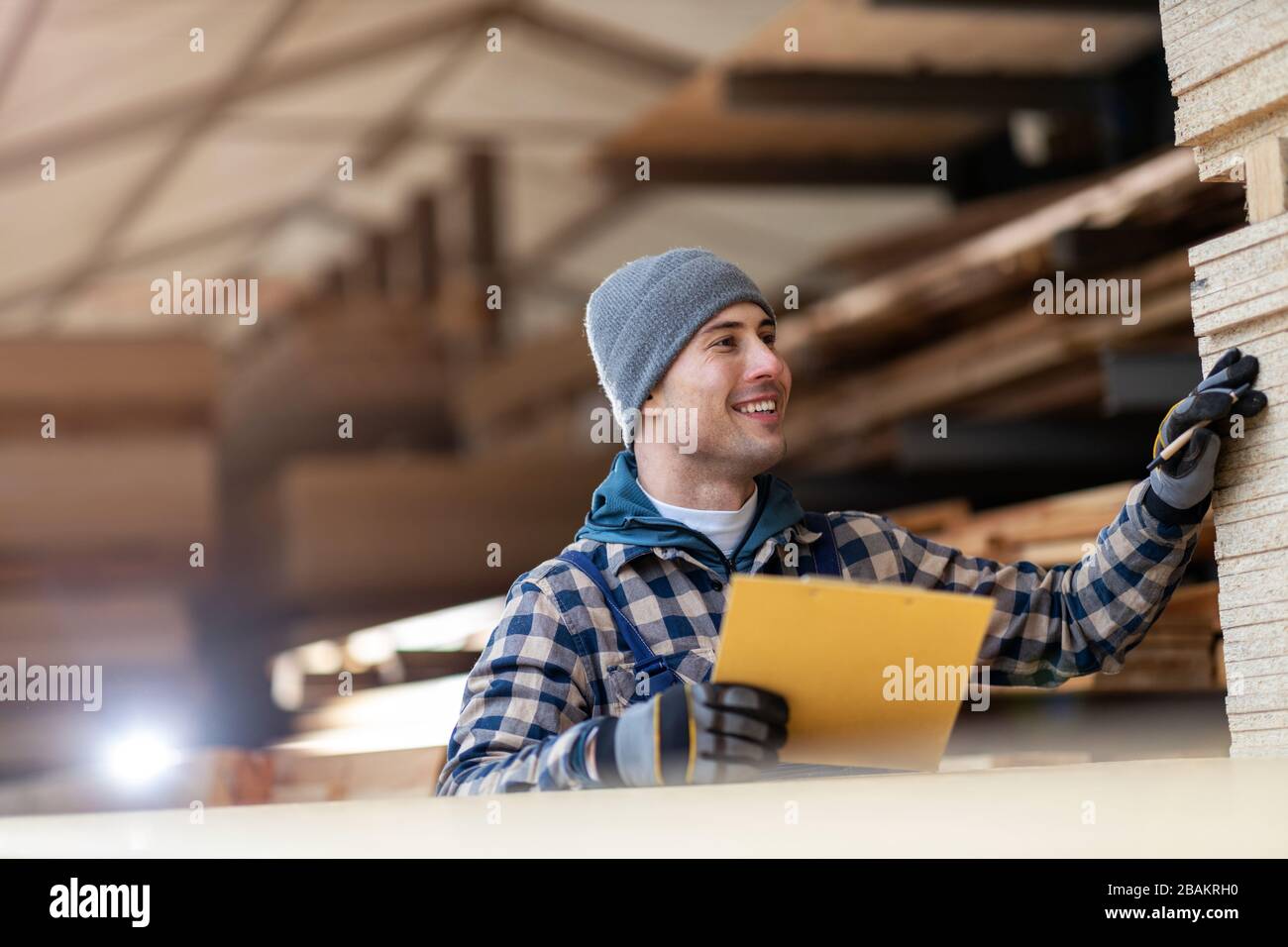Young male worker in timber warehouse Stock Photo