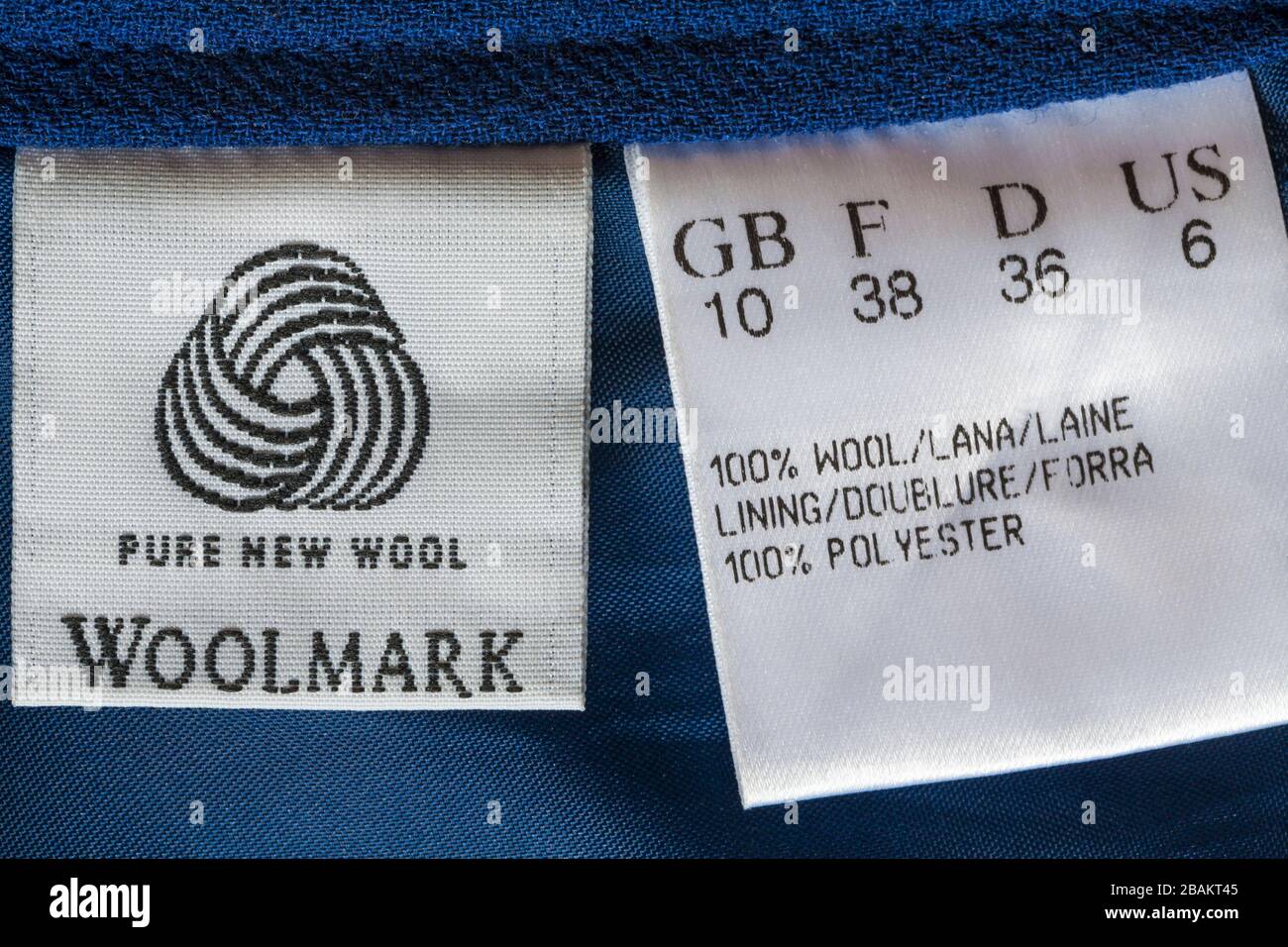 Woolmark pure new wool symbol on label in woman's blue suit clothing - 100% wool, lining 100% polyester Stock Photo