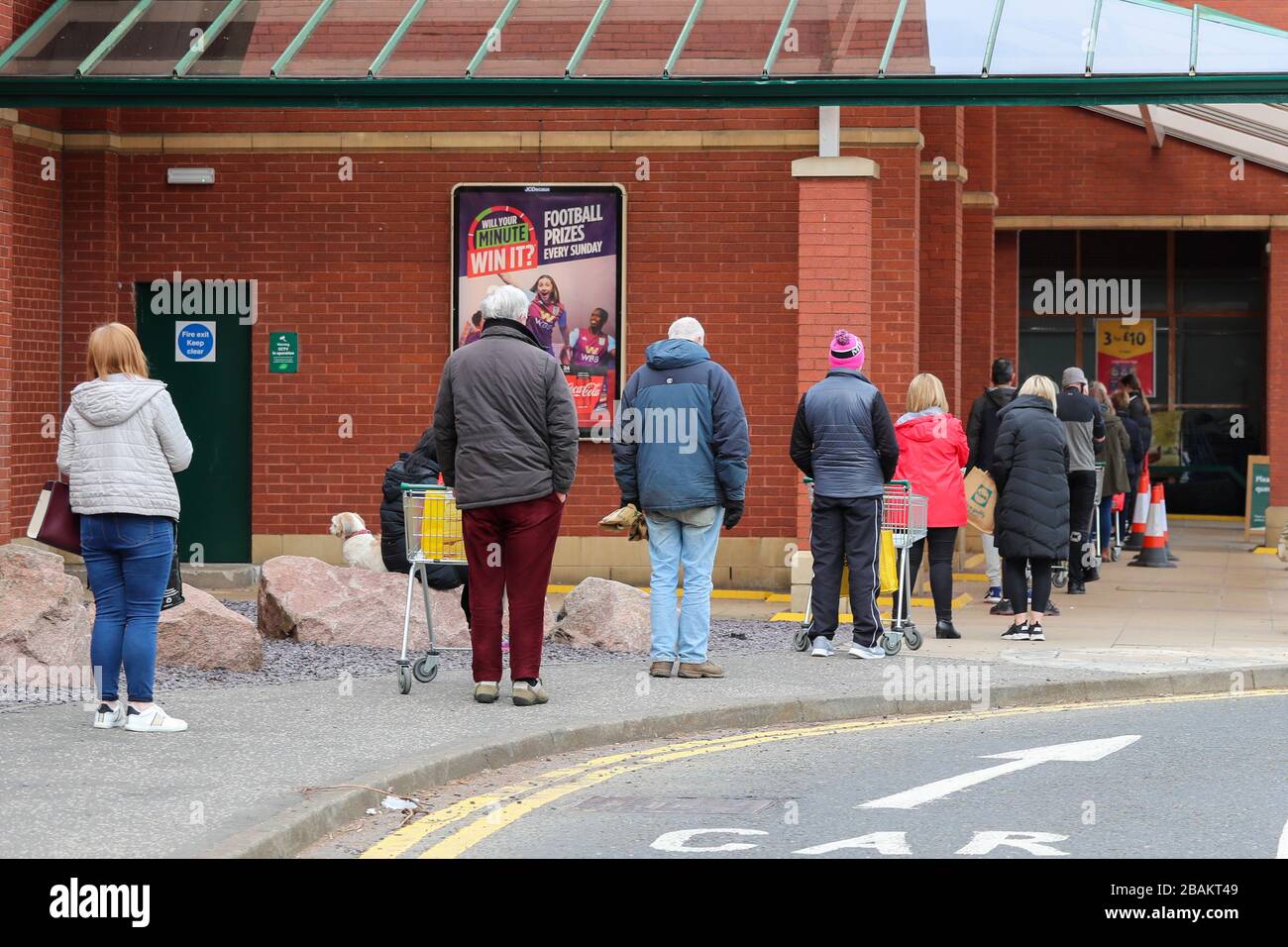 Ayr, UK. 28th Mar, 2020. In accordance with the Government's instructions, most people stay away from the normally popular and busy shopping centres and streets of Ayr leaving an almost empty town centre except for a few food retailers and pharmacies. Customer stand in an orderly queue, keeping 2 metres apart, waiting to be allowed in to shop at Morrison's supermarket, Ayr. Credit: Findlay/Alamy Live News Stock Photo