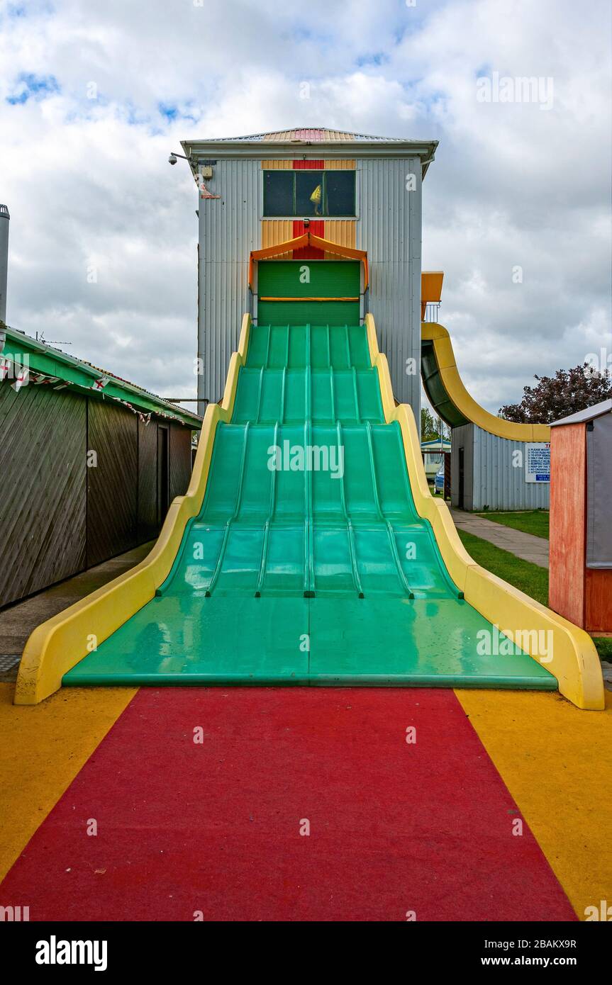 https://c8.alamy.com/comp/2BAKX9R/the-roller-shutter-doors-of-the-tall-rectangular-amusement-park-type-fun-tower-are-closed-to-prevent-access-to-the-highsmoothwavy-multi-slide-2BAKX9R.jpg