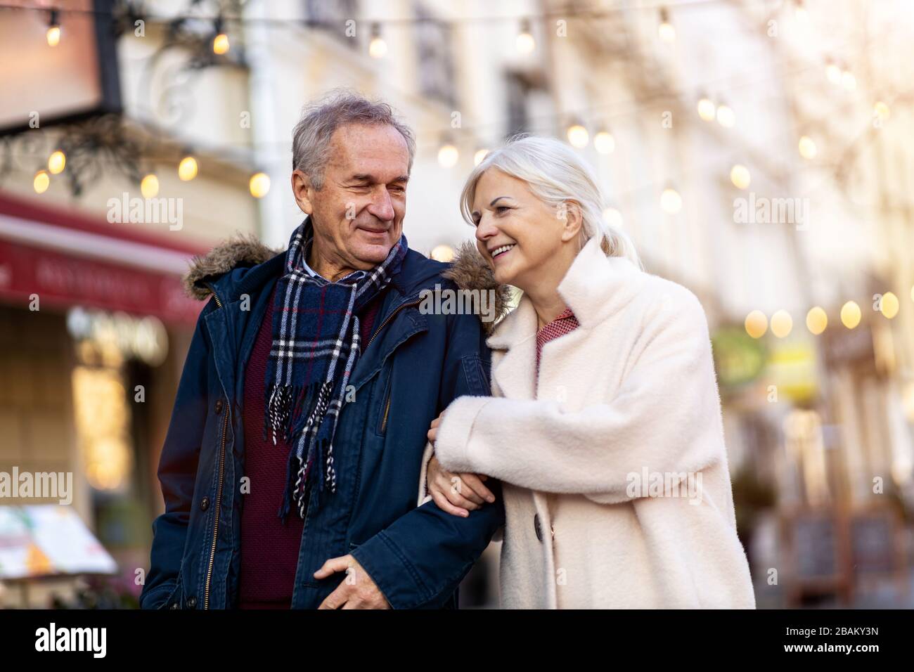Elderly Couple Having Fun Outdoors At Christmas Time Stock Photo