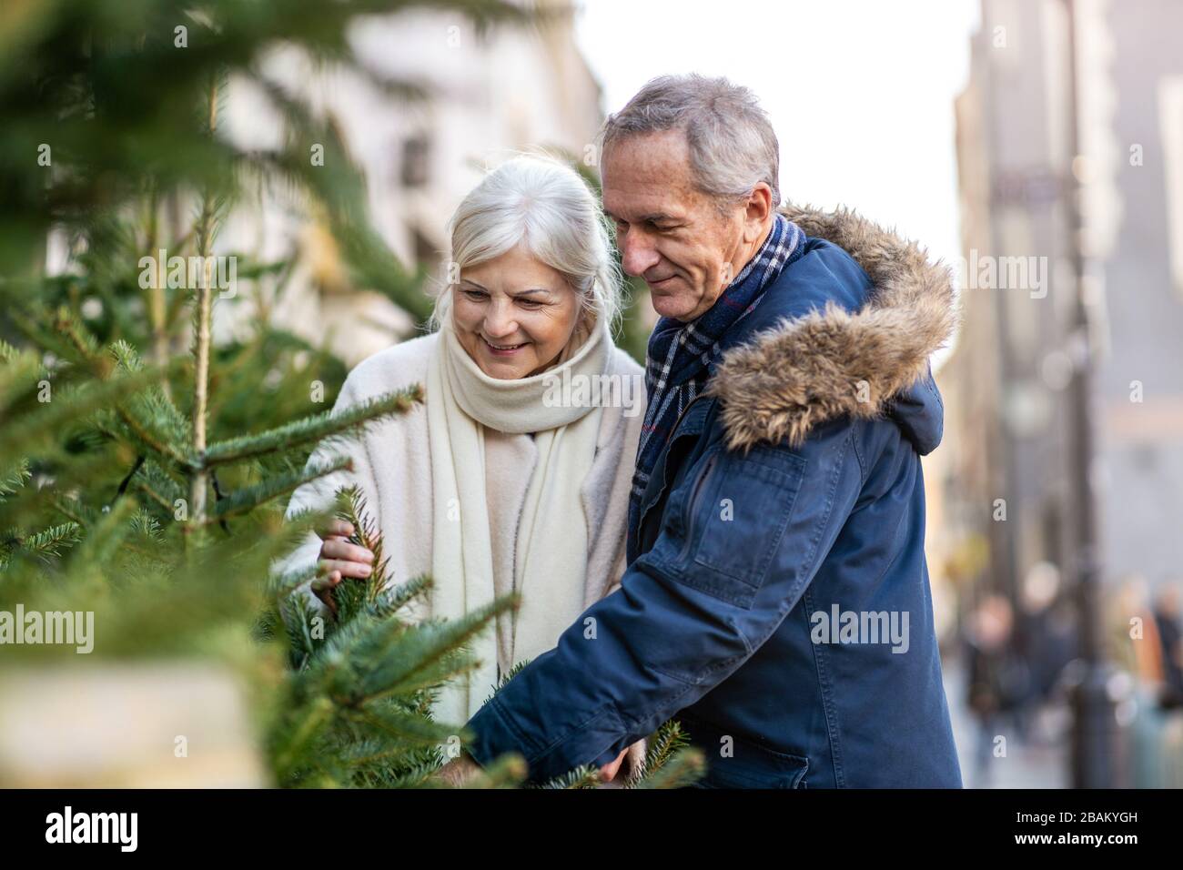 Elderly Couple Having Fun Outdoors At Christmas Time Stock Photo