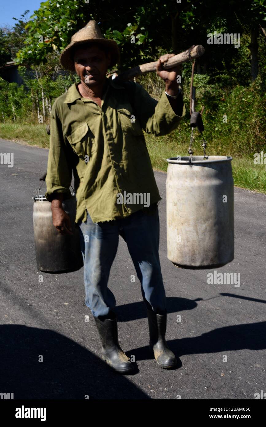 Person, man, carrying brass, road, 2014, Cuba Stock Photo