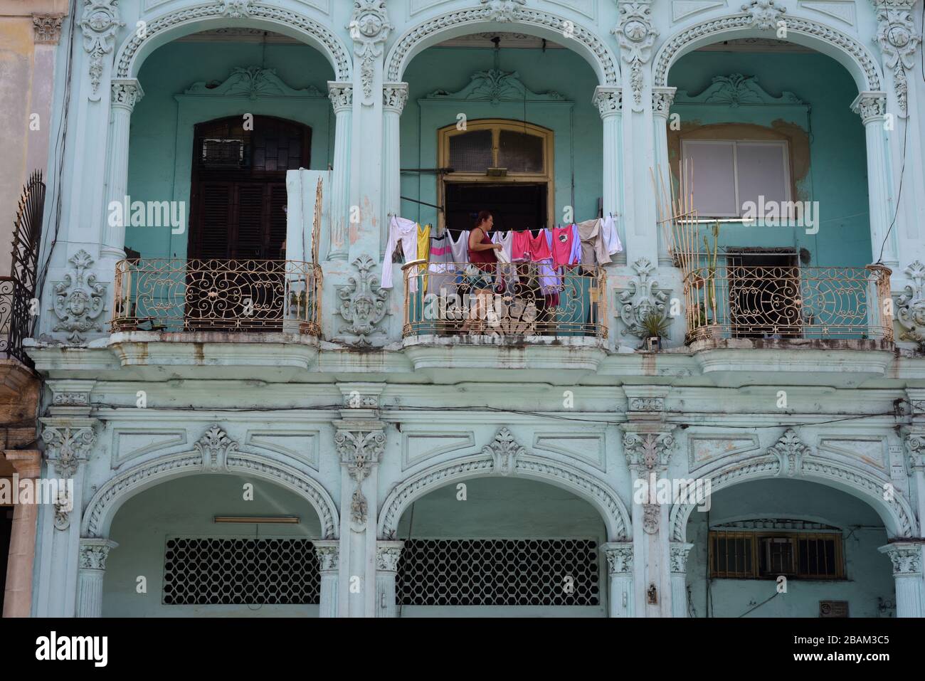 Person, woman, tenement, street, 2014, Cuba Stock Photo