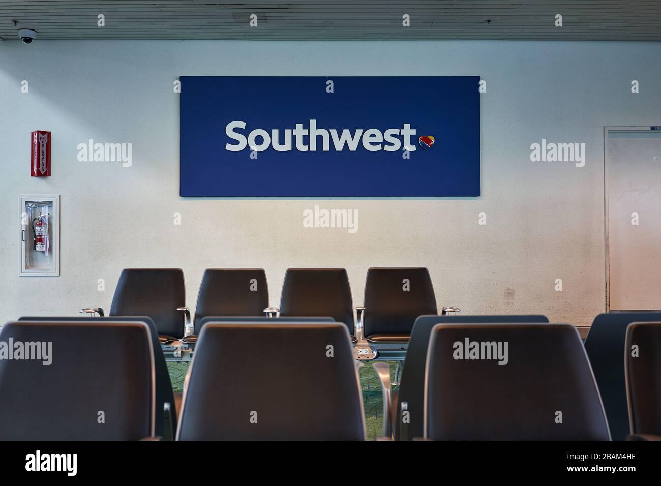 The Southwest sign is seen at a boarding gate in Portland International Airport on Feb 7, 2020, with rows of empty seats in the foreground. Stock Photo
