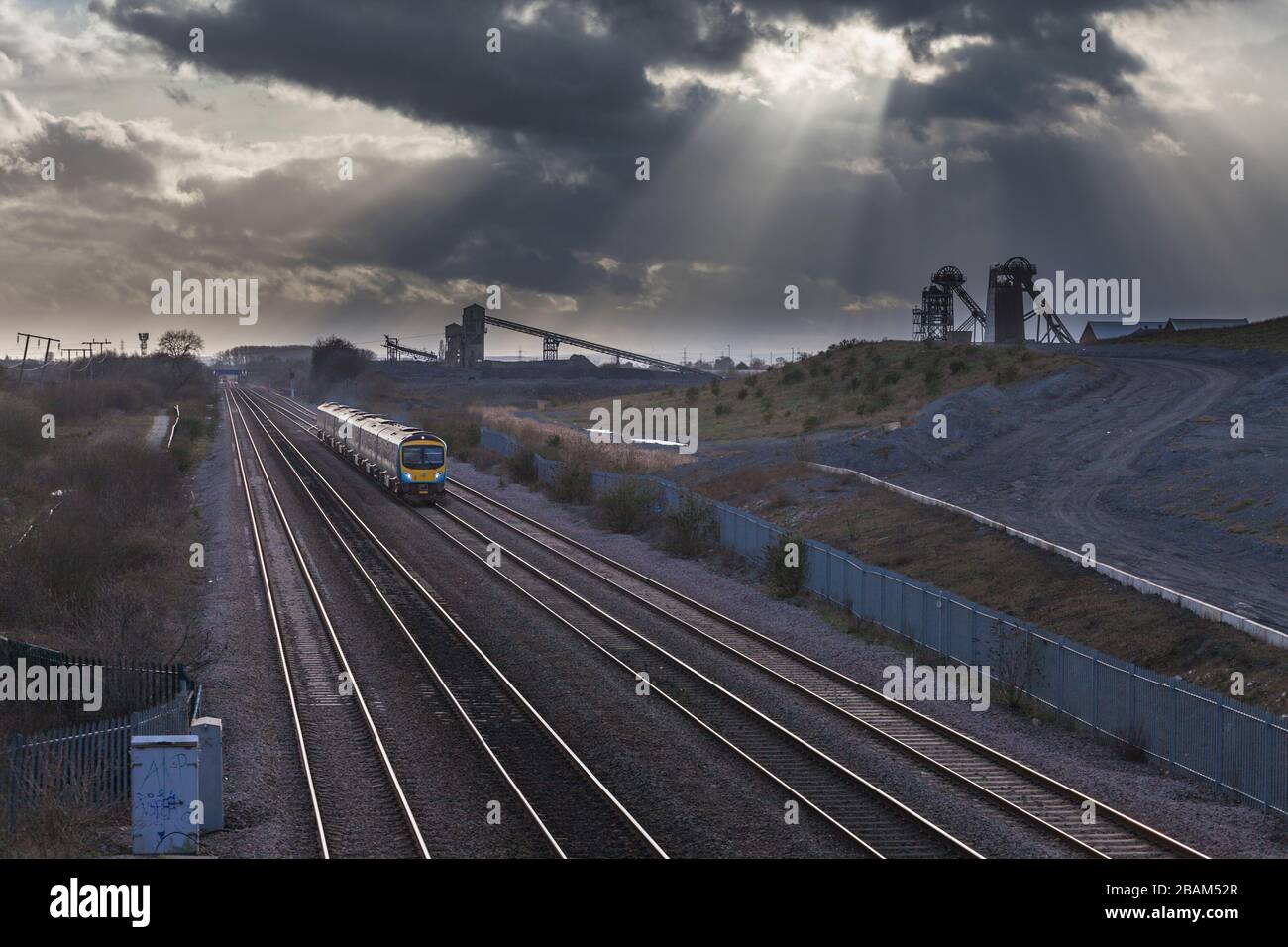 2 First transpennine Express class 185's passing the closed Hatfield colliery with the headstocks and dark clouds Stock Photo