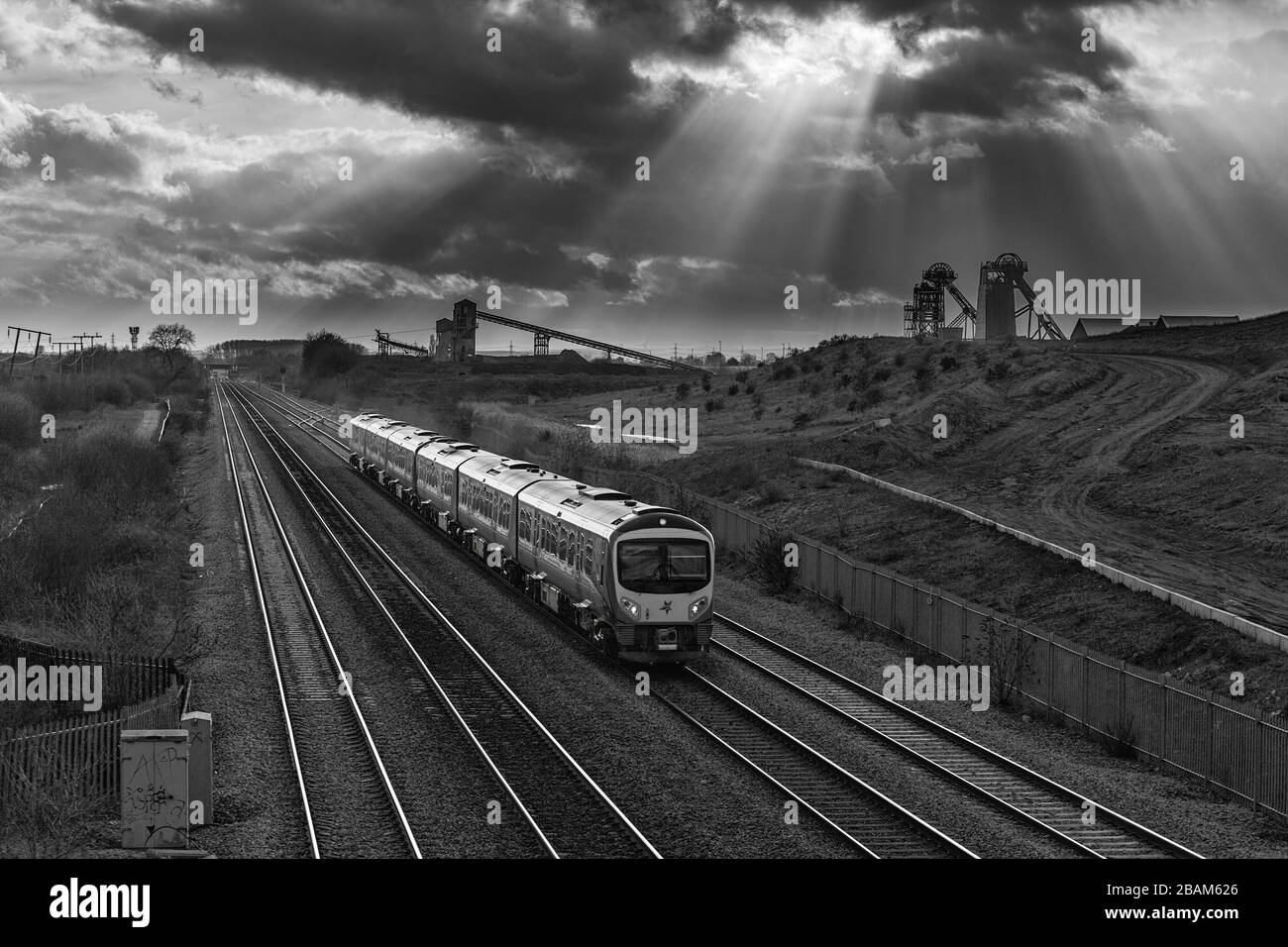 2 First transpennine Express class 185's passing the closed Hatfield colliery with the headstocks and dark clouds Stock Photo