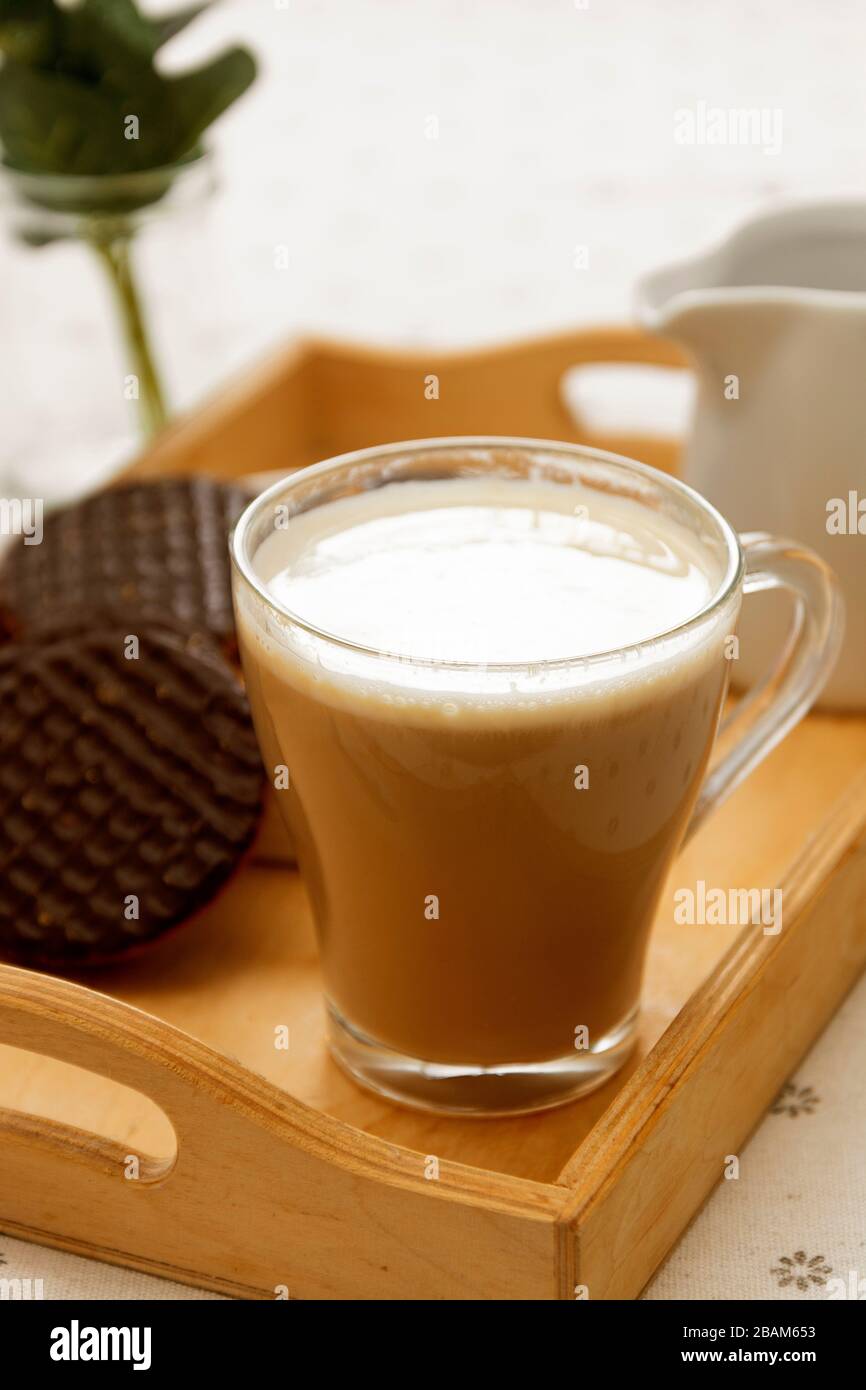 https://c8.alamy.com/comp/2BAM653/latte-coffee-glass-cup-of-coffee-and-milk-with-chocolate-biscuit-2BAM653.jpg