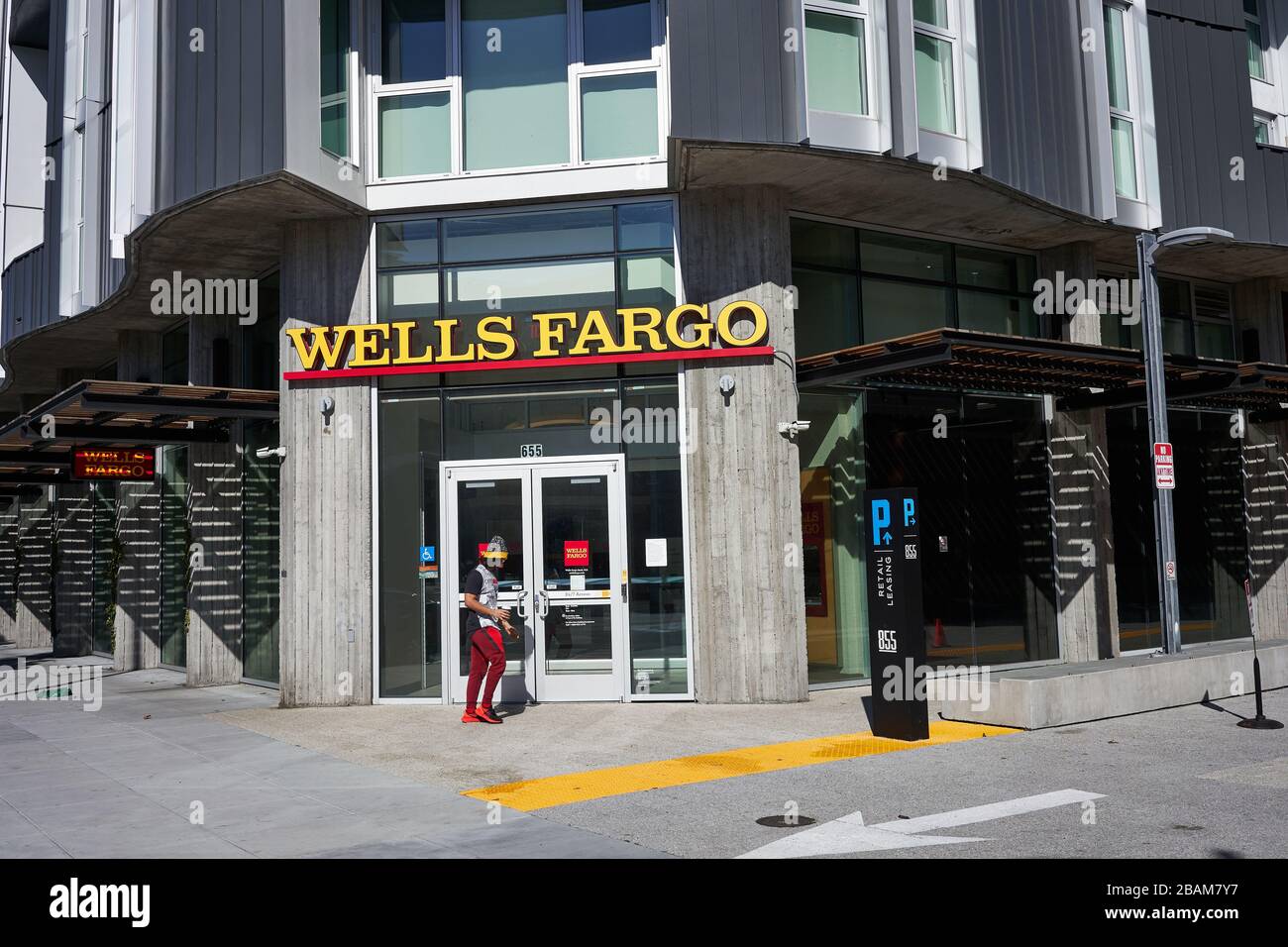 A man walks past a branch of Wells Fargo Bank in the SoMa District of San Francisco, California, on Sunday, Feb 9, 2020. Stock Photo